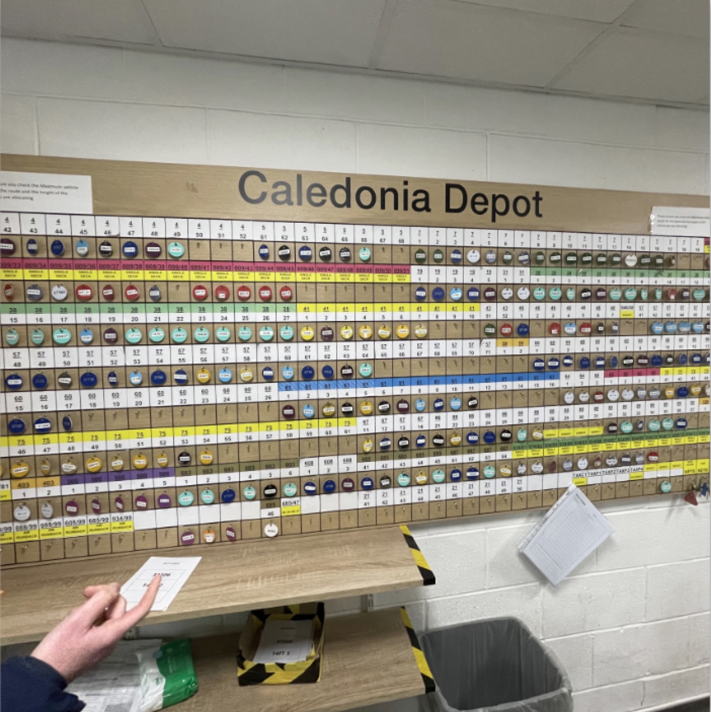 A depot wall where vehicle allocation is tracked with physical pegs and paper tickets